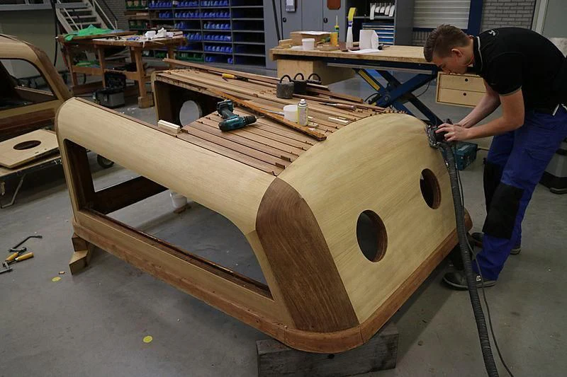 a person working on a wooden boat aboard VAGRANT Yacht for Sale