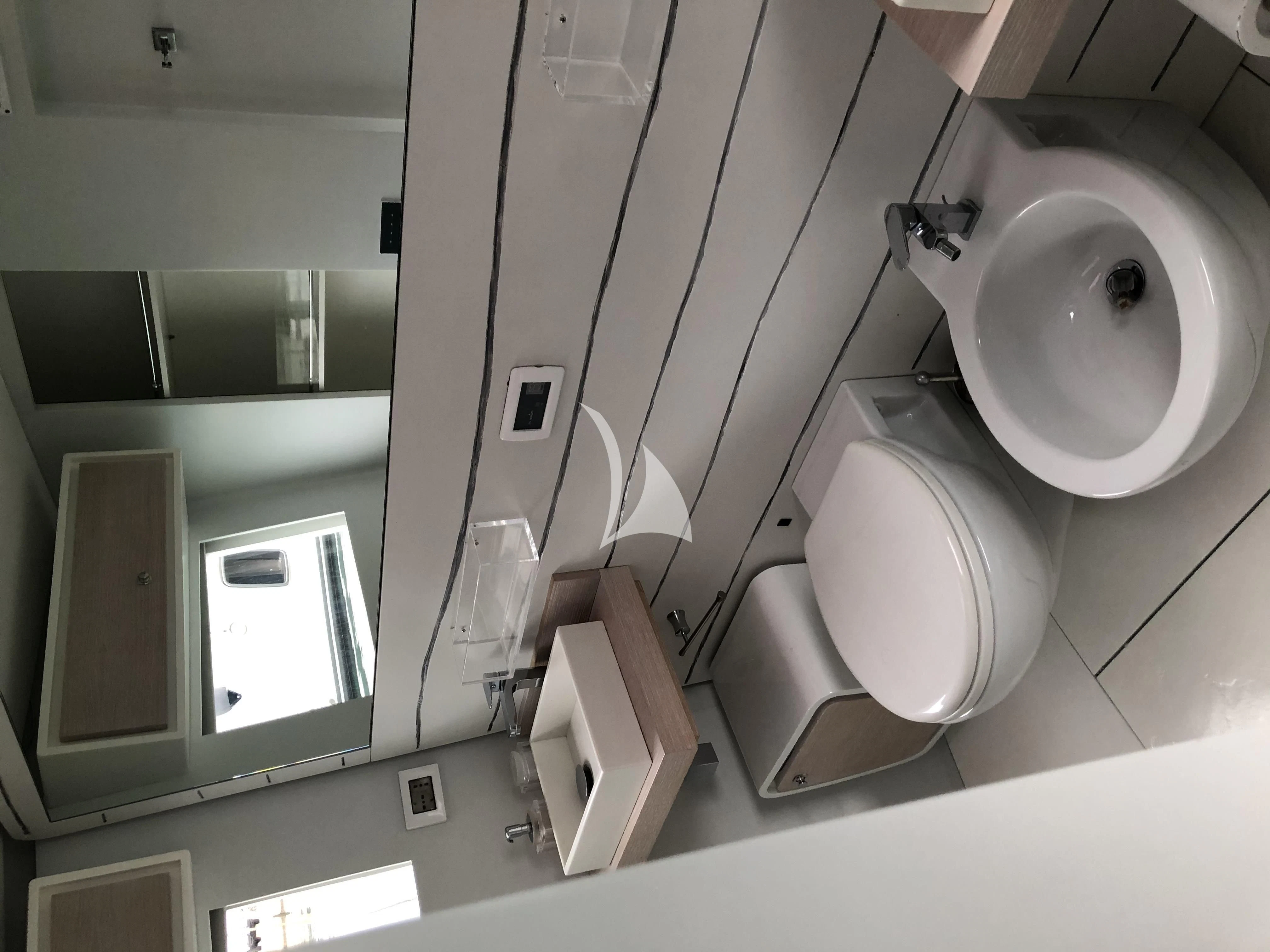 a bathroom with a toilet and a sink aboard LUCE GUIDA Yacht for Sale