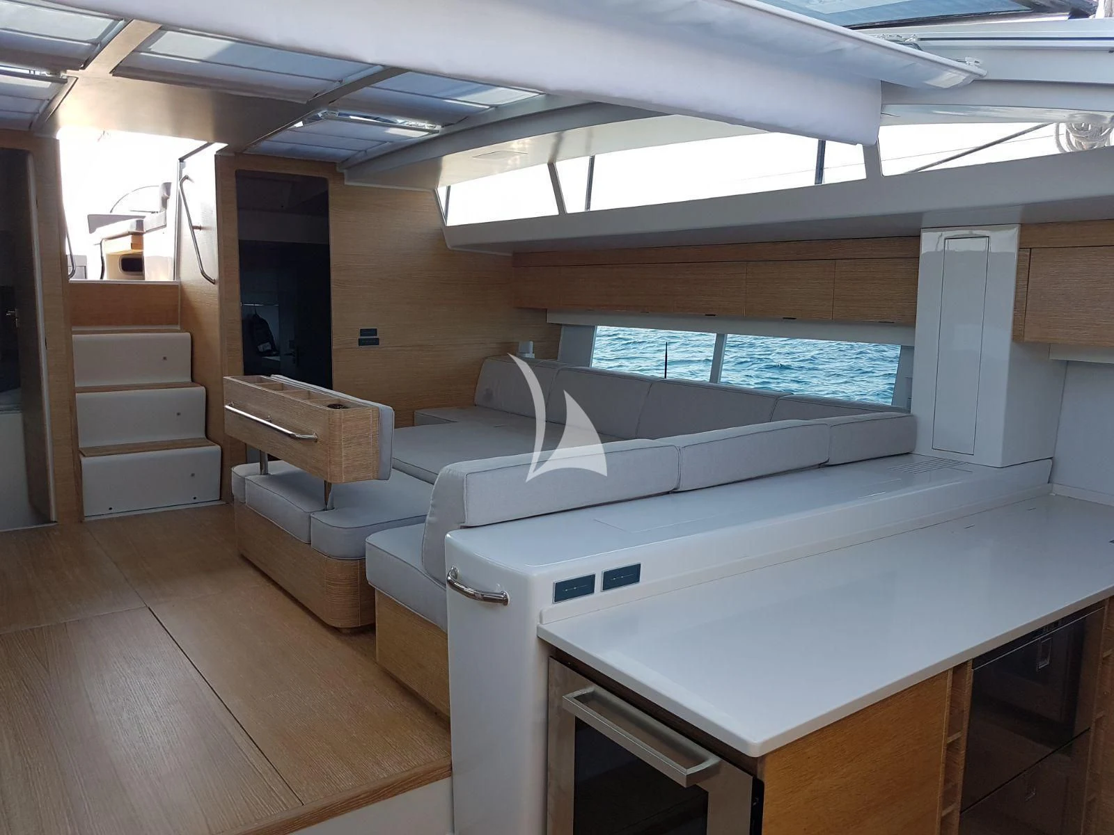 a room with a couch and a large window aboard LUCE GUIDA Yacht for Sale
