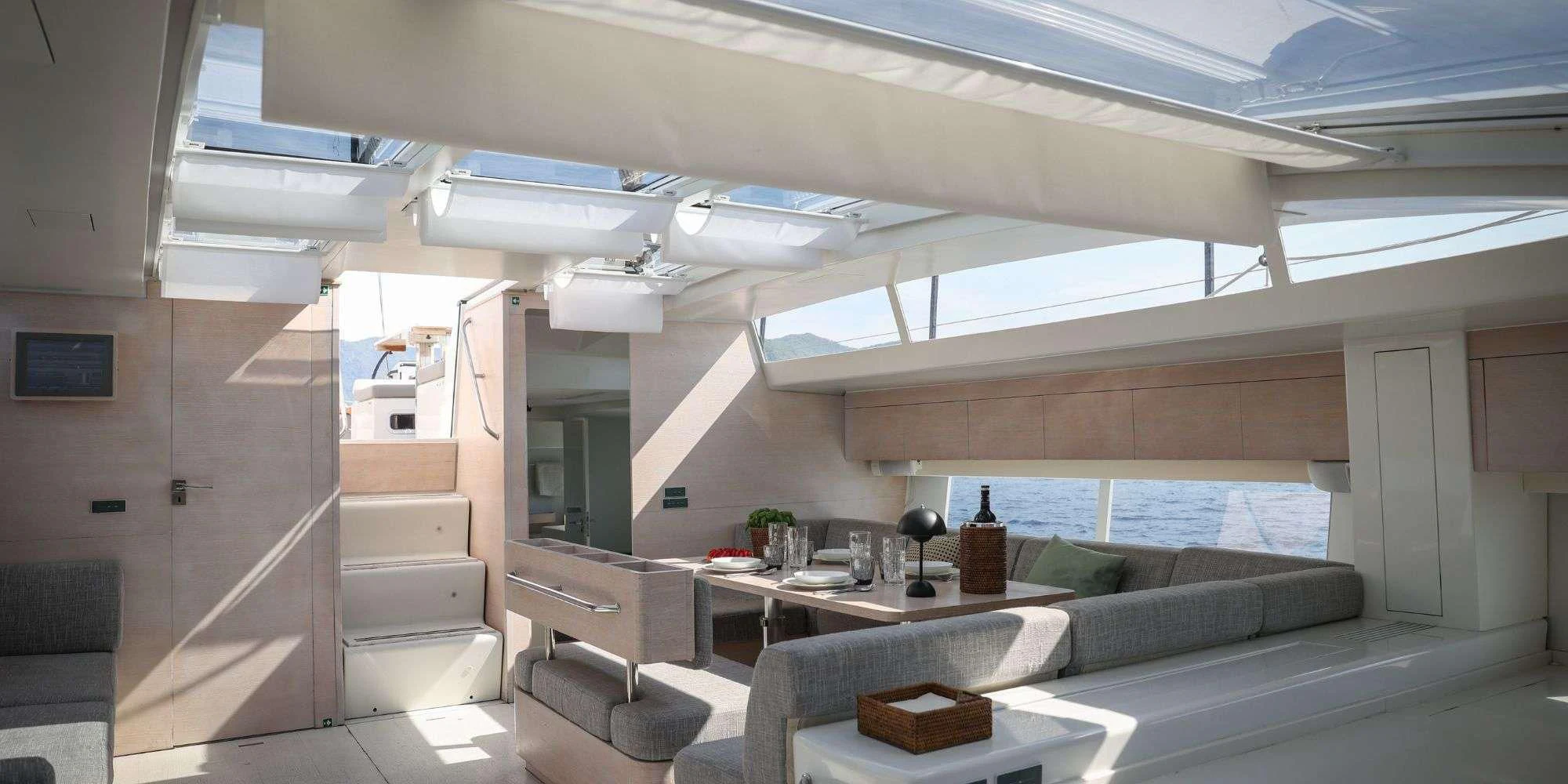 a room with a couch and a table and a window aboard LUCE GUIDA Yacht for Sale