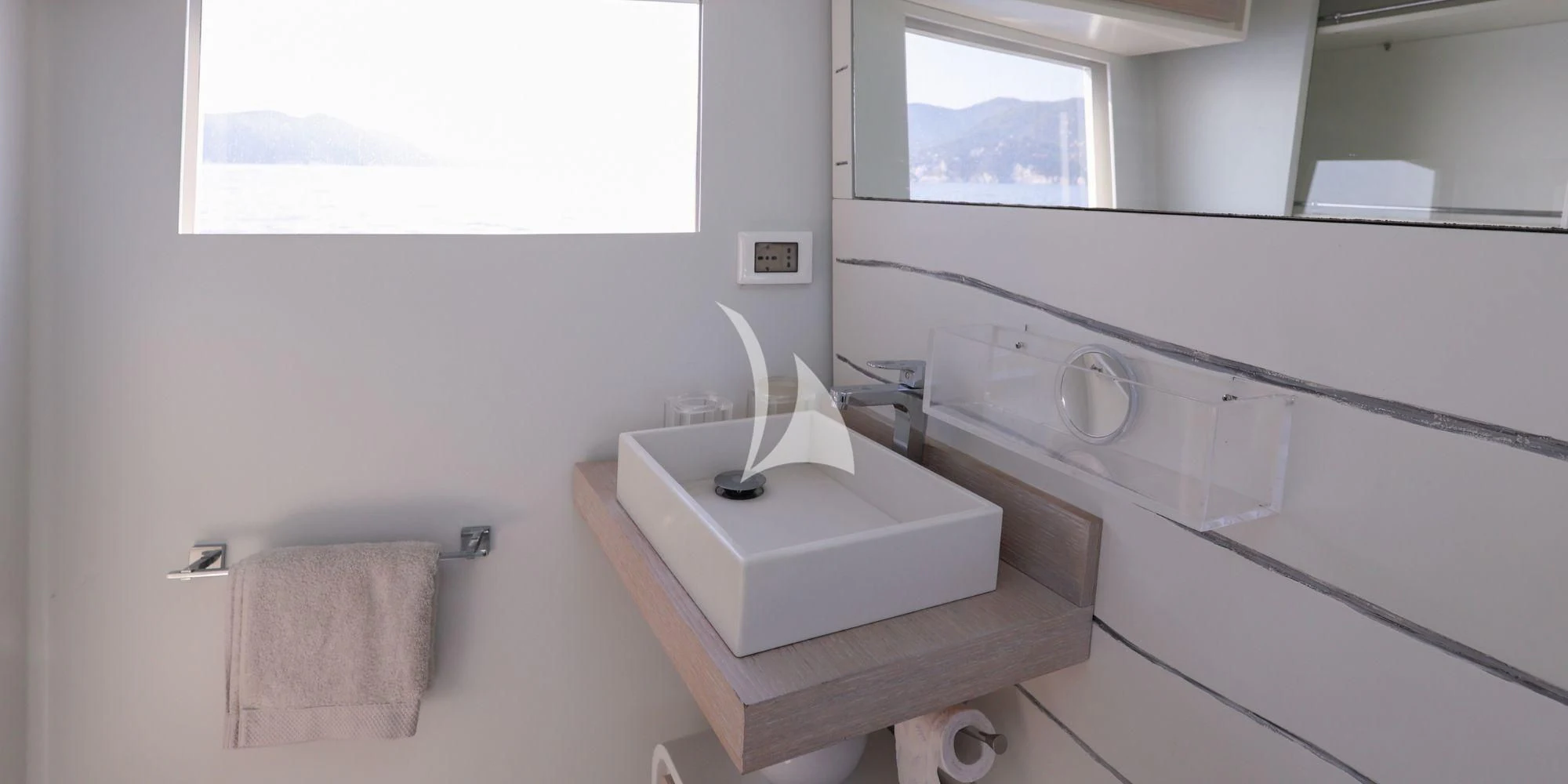 a bathroom with a sink and a mirror aboard LUCE GUIDA Yacht for Sale