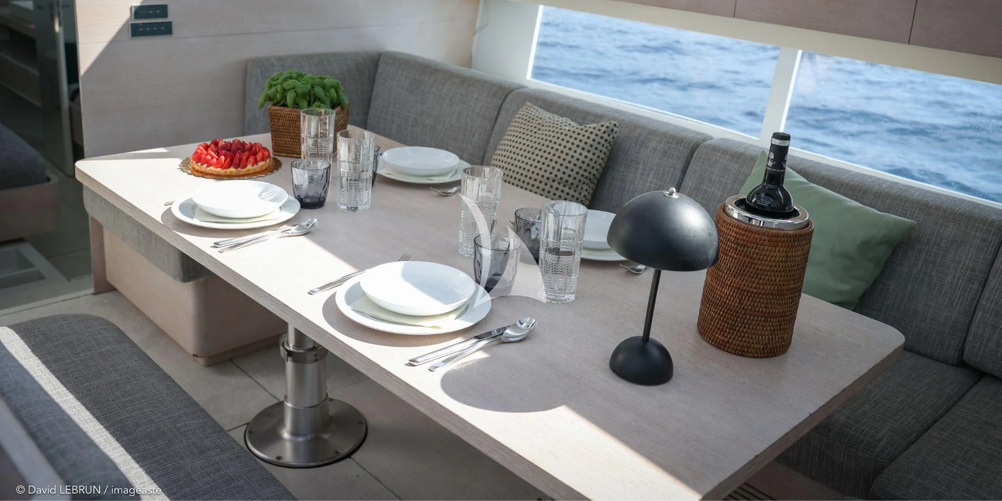 a table with plates and glasses on it aboard LUCE GUIDA Yacht for Sale