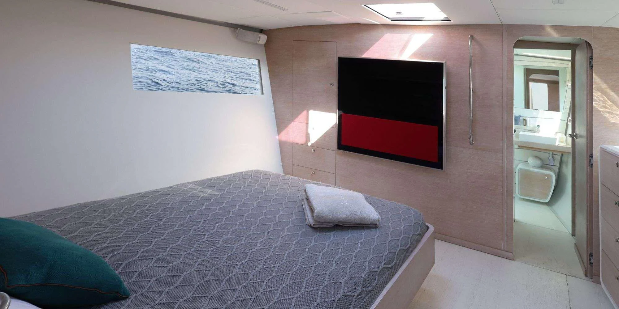 a room with a bed and a tv aboard LUCE GUIDA Yacht for Sale