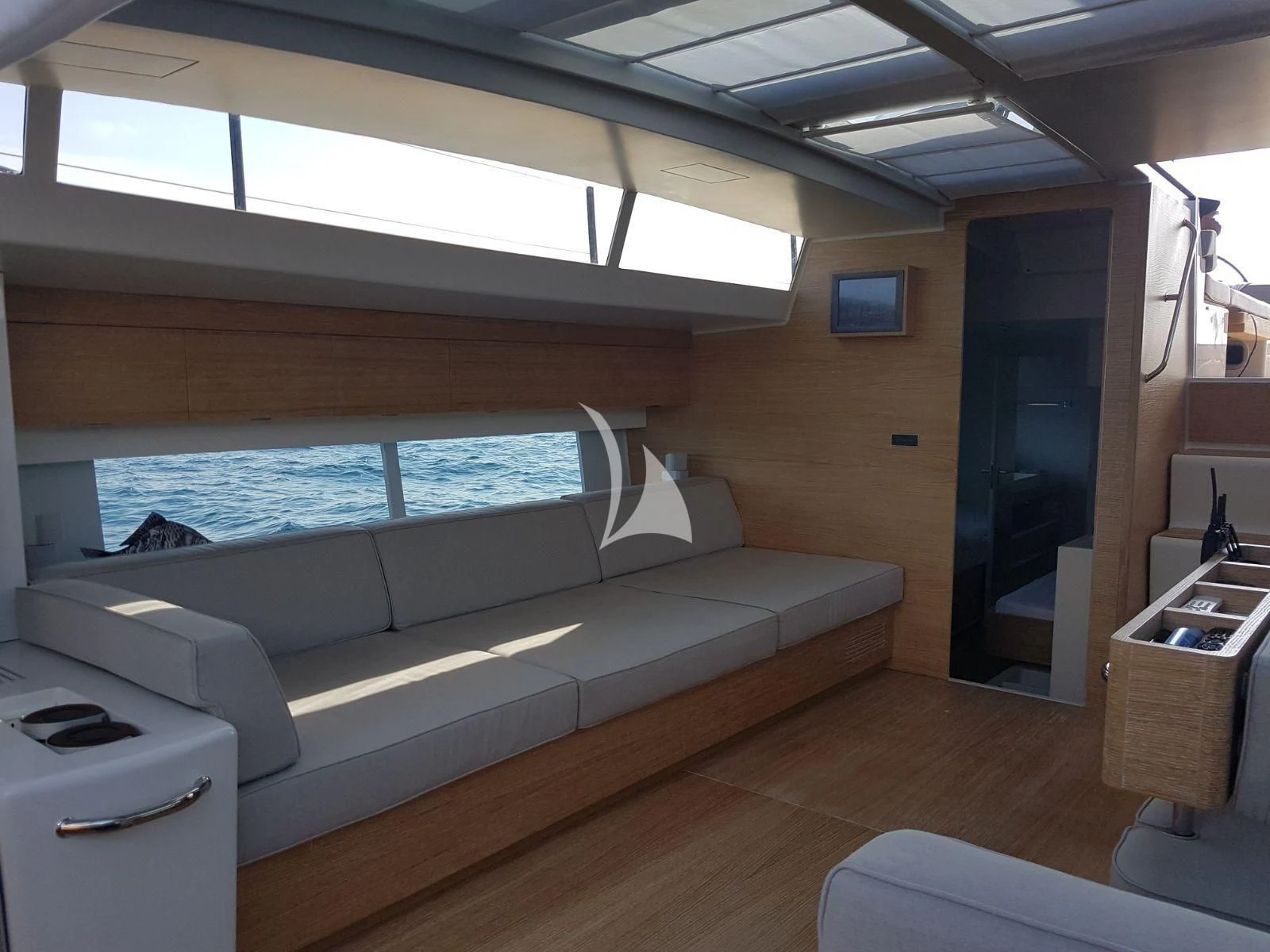 a room with a couch and a window aboard LUCE GUIDA Yacht for Sale