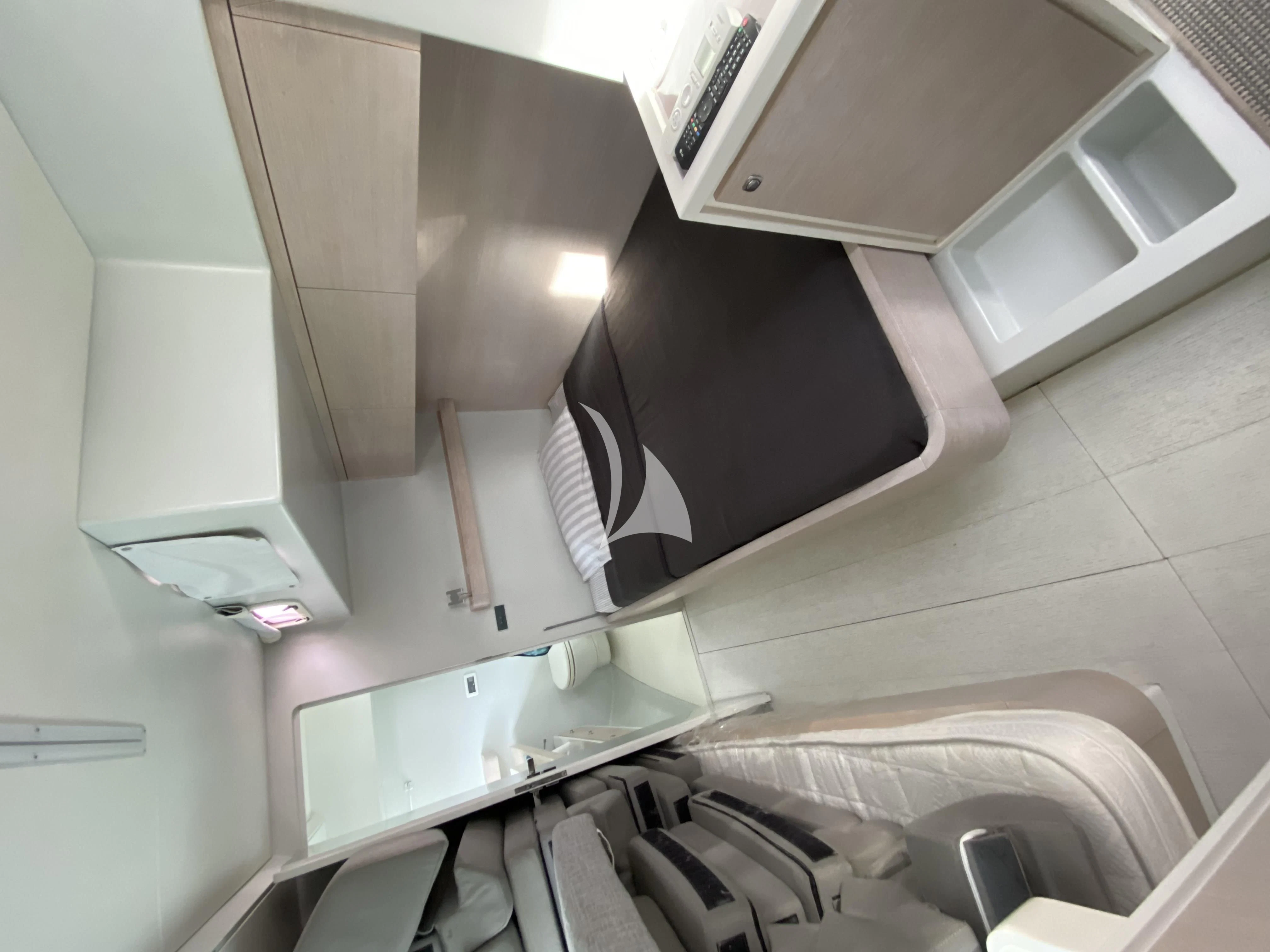 a white room with a sink and a black microwave aboard LUCE GUIDA Yacht for Sale