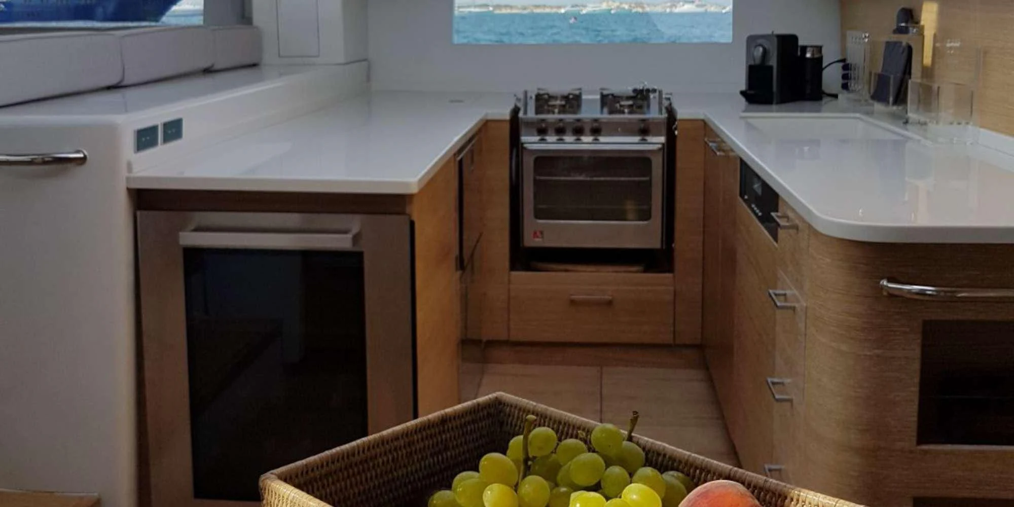 a kitchen with a microwave oven and fruit on the floor aboard LUCE GUIDA Yacht for Sale
