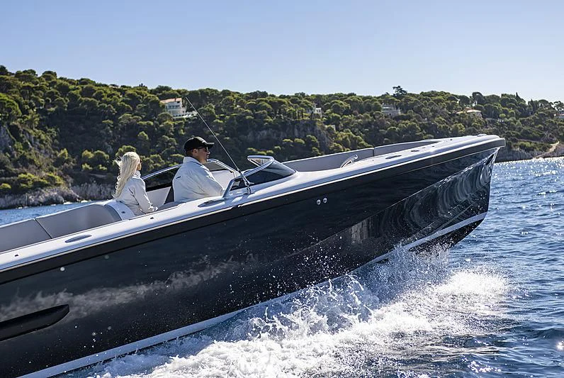 a man and woman on a speedboat on the water aboard M'BRACE Yacht for Sale