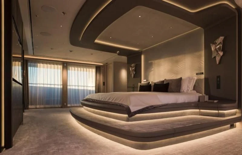 a large bedroom with a large bed aboard M'BRACE Yacht for Sale