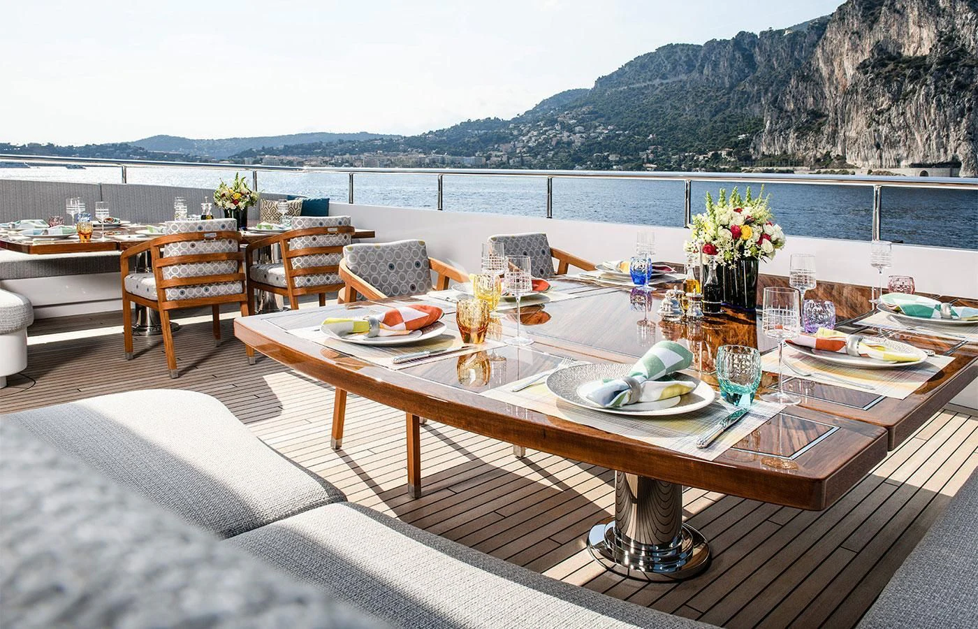 a table with plates and glasses on it aboard M'BRACE Yacht for Sale