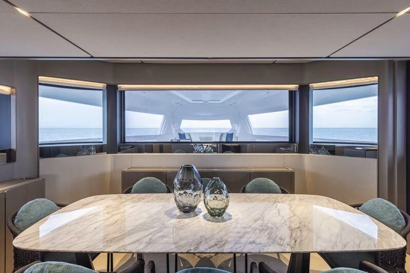 a table with glasses on it aboard INFYNITO 90/01 Yacht for Sale