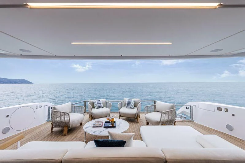 a room with a table chairs and a view of the ocean aboard INFYNITO 90/01 Yacht for Sale