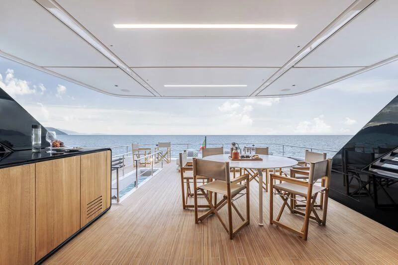 a room with a table and chairs aboard INFYNITO 90/01 Yacht for Sale