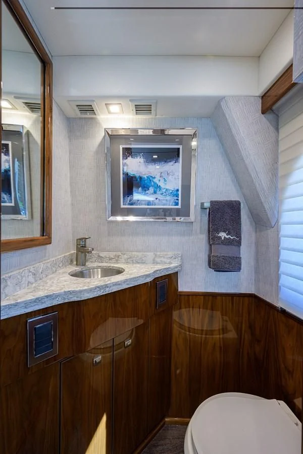 a bathroom with a painting on the wall aboard QUICK RAISE Yacht for Sale