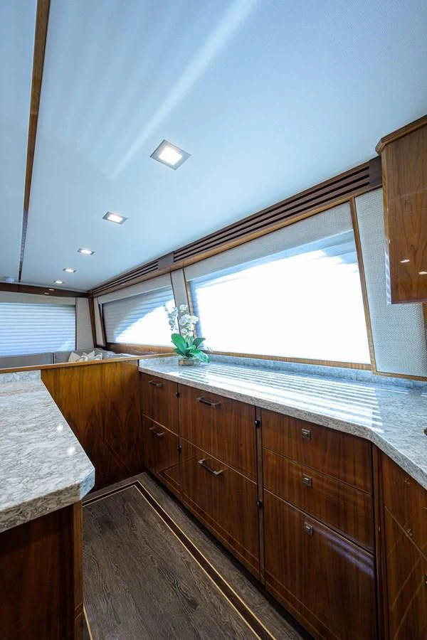 a kitchen with wooden cabinets aboard QUICK RAISE Yacht for Sale