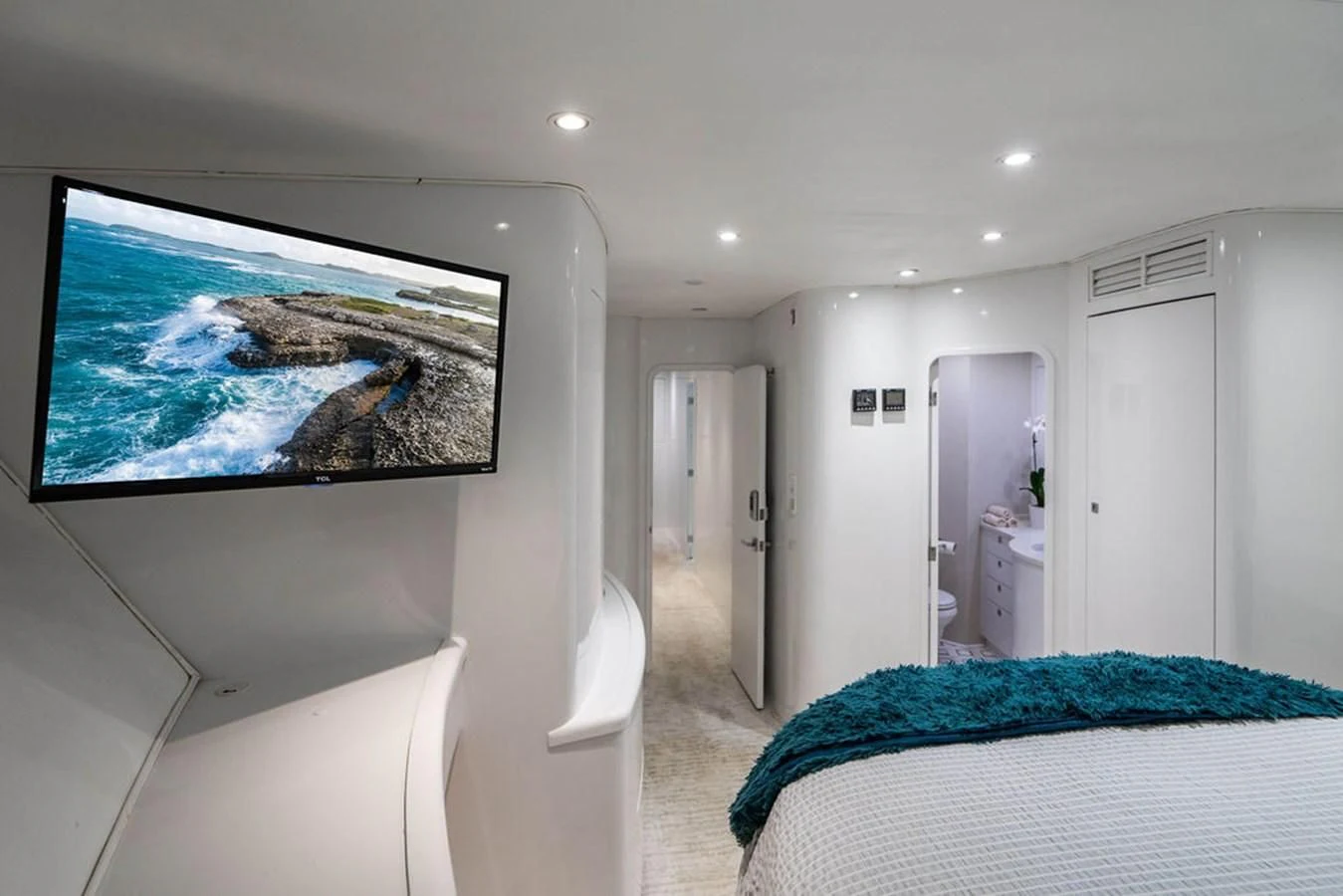 a bedroom with a tv on the wall aboard COURTNEY ANNE Yacht for Sale