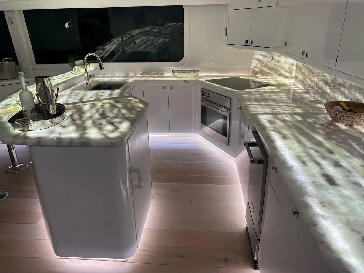 a kitchen with white cabinets aboard COURTNEY ANNE Yacht for Sale
