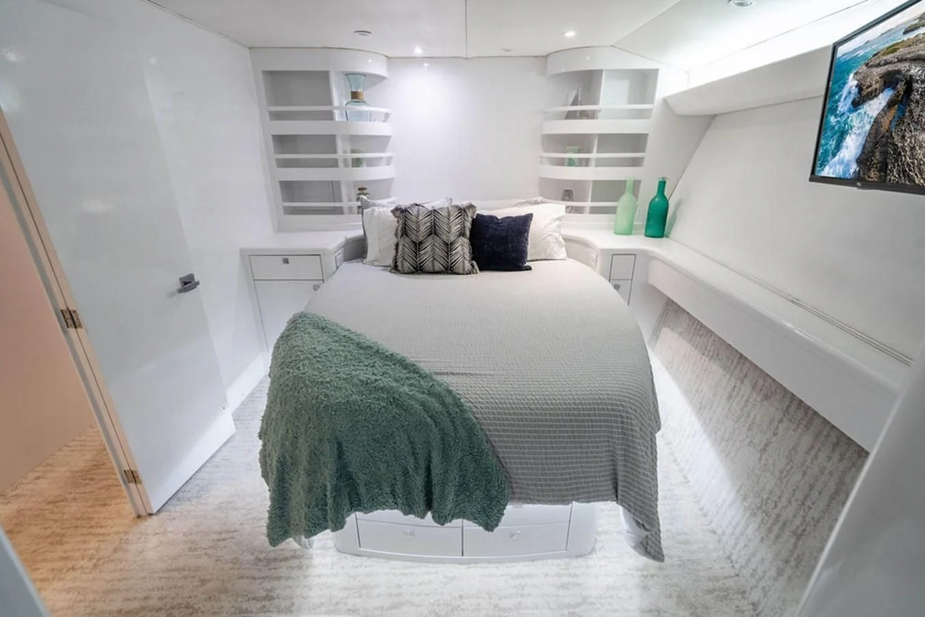 a bedroom with a bed and a shelf aboard COURTNEY ANNE Yacht for Sale