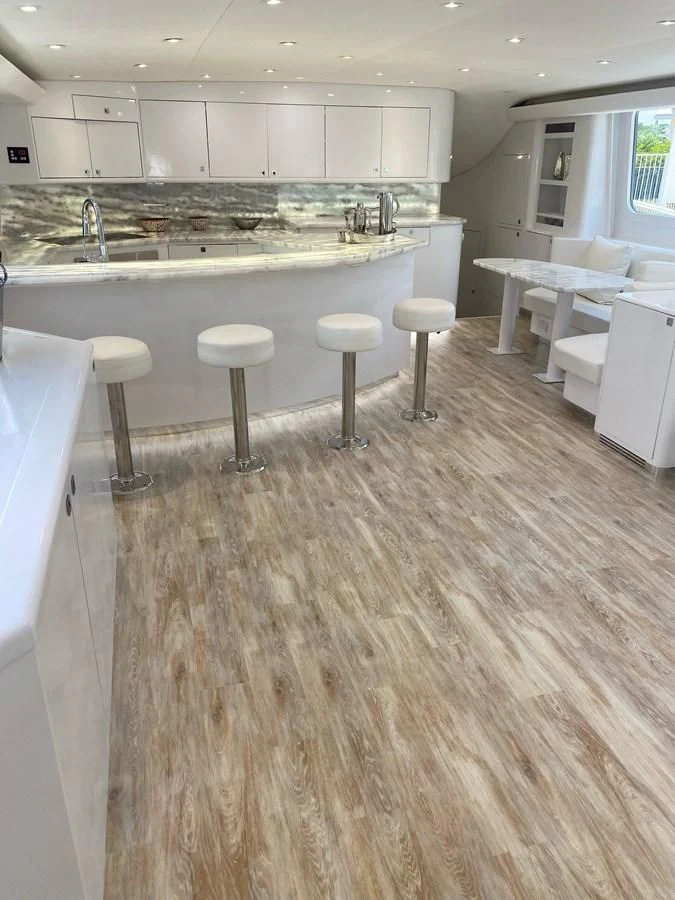 a kitchen with stools and stools aboard COURTNEY ANNE Yacht for Sale