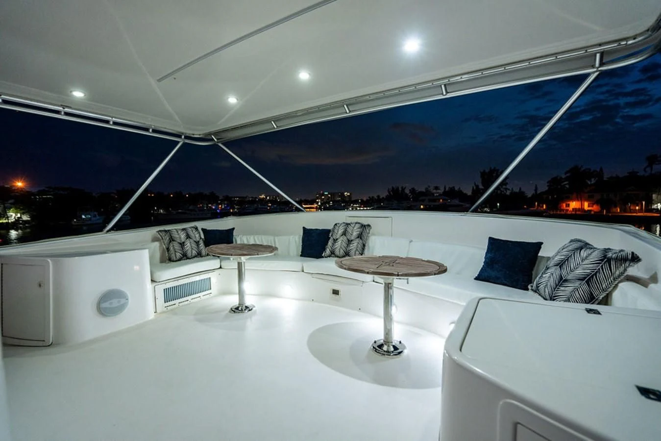 a room with a couch and a table and a large white wall with lights aboard COURTNEY ANNE Yacht for Sale