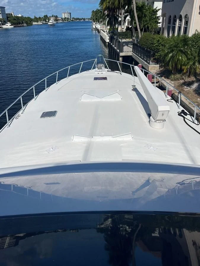 a white boat on the water aboard COURTNEY ANNE Yacht for Sale