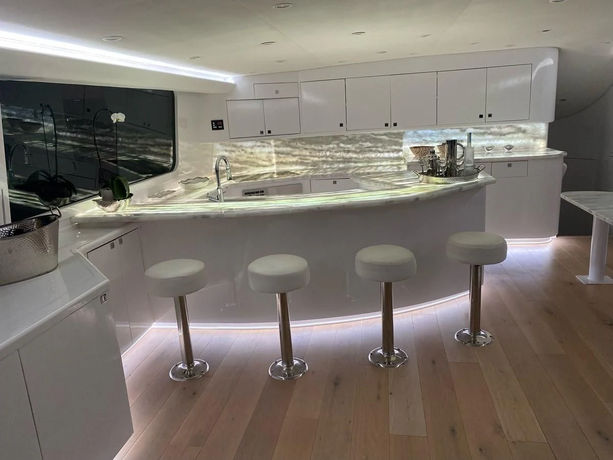 a kitchen with stools and stools aboard COURTNEY ANNE Yacht for Sale