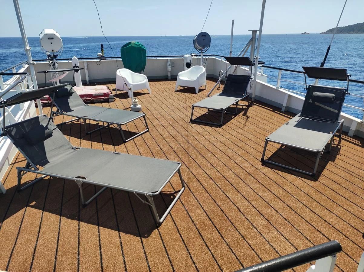 a deck with a deck and chairs on it aboard TE STREEP Yacht for Sale