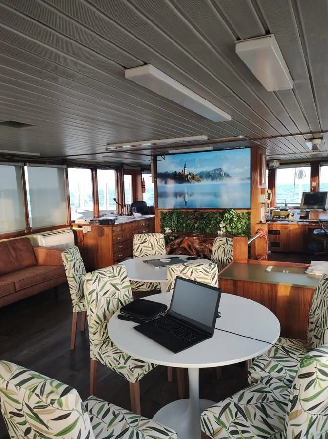 a living room with a laptop on a table aboard TE STREEP Yacht for Sale
