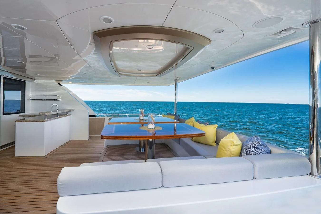 a room with a table and a couch aboard SEA N SEA Yacht for Sale