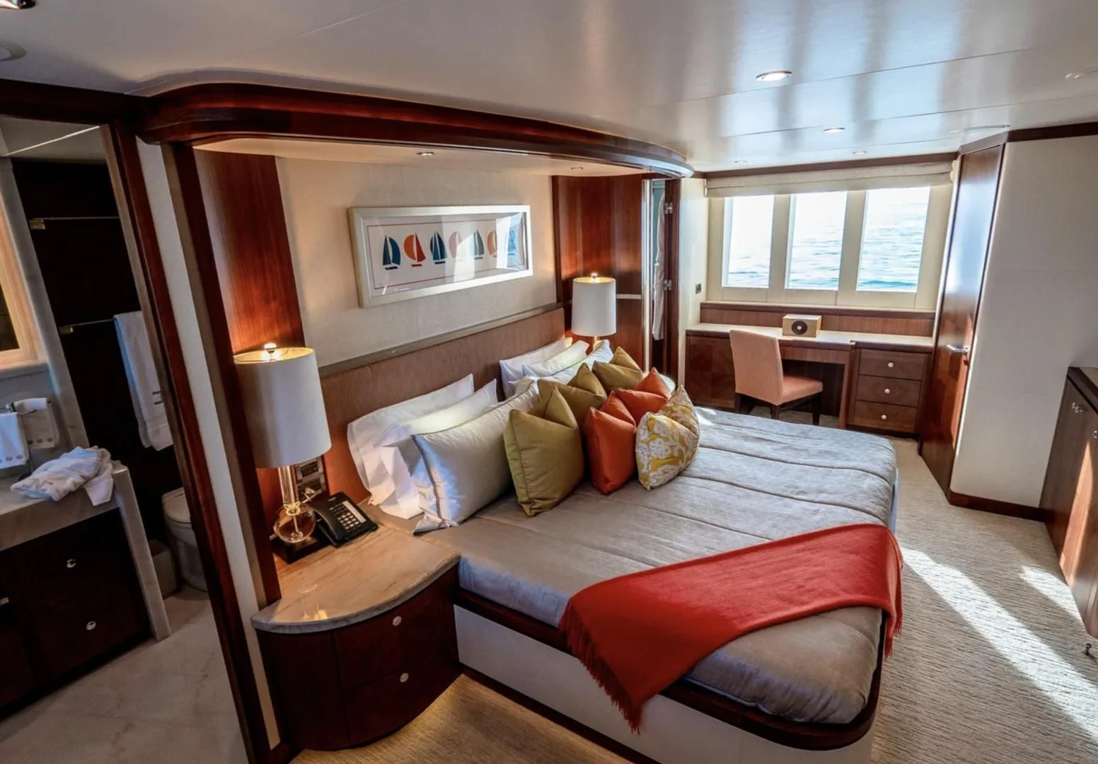 a bedroom with a bed and a desk aboard SEA N SEA Yacht for Sale