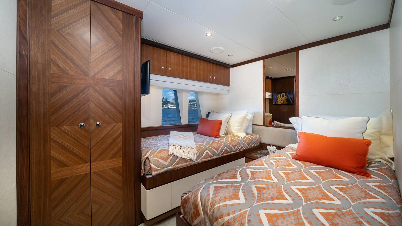 a room with a bed and a wood cabinet aboard SEA N SEA Yacht for Sale