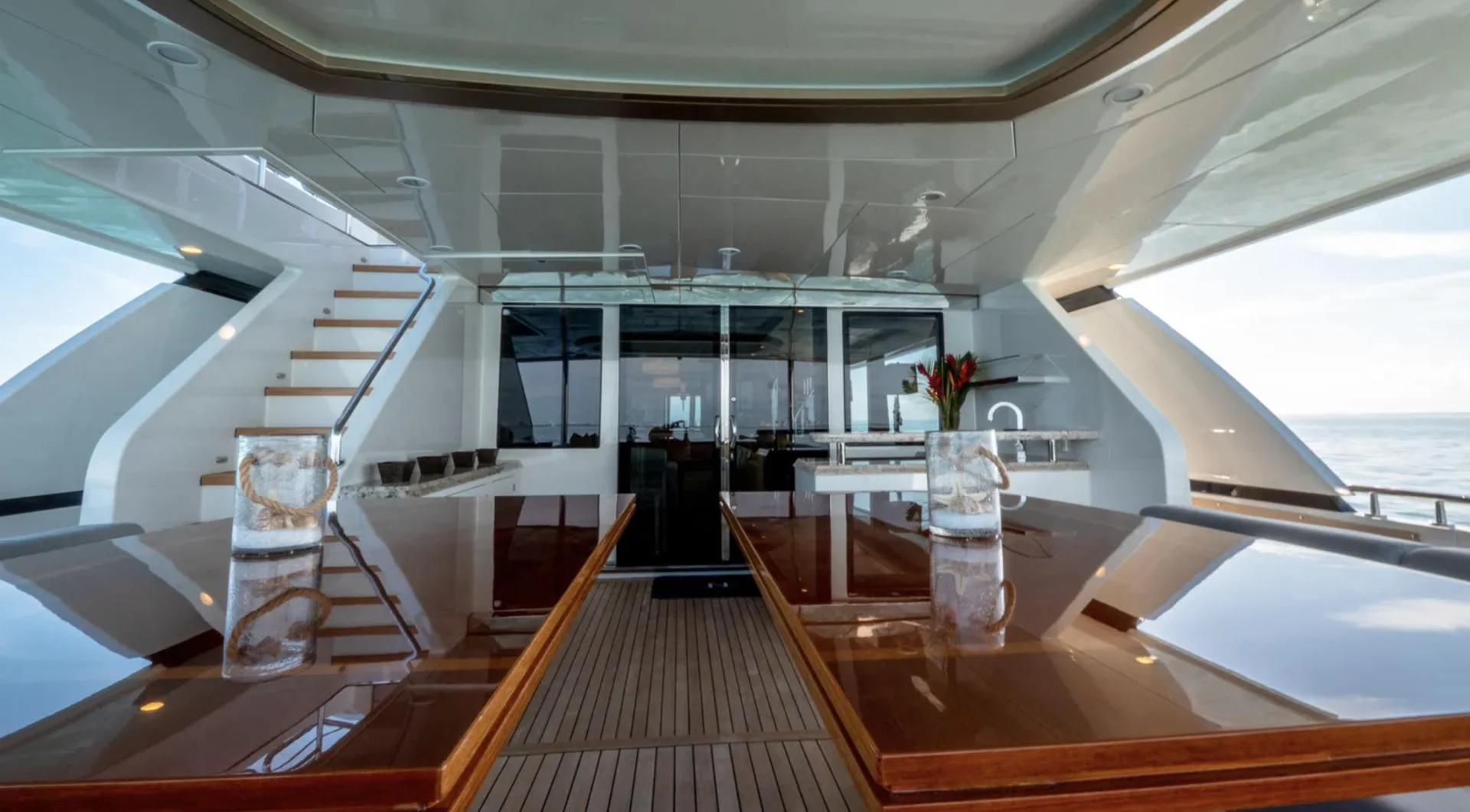 a room with a wood floor and a staircase aboard SEA N SEA Yacht for Sale