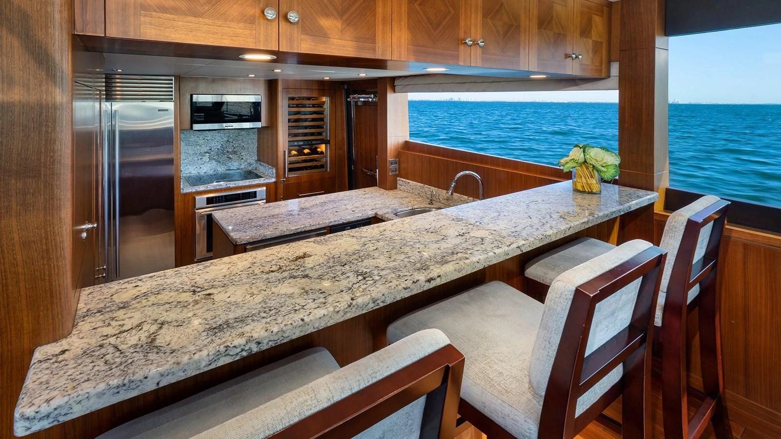 a kitchen with a table and chairs aboard SEA N SEA Yacht for Sale