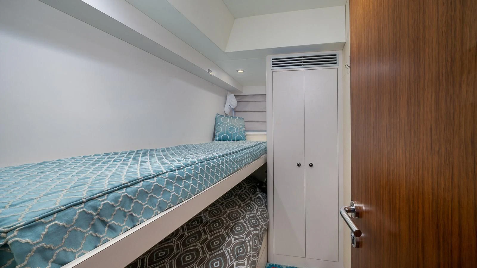 a bed with a blue sheet aboard SEA N SEA Yacht for Sale