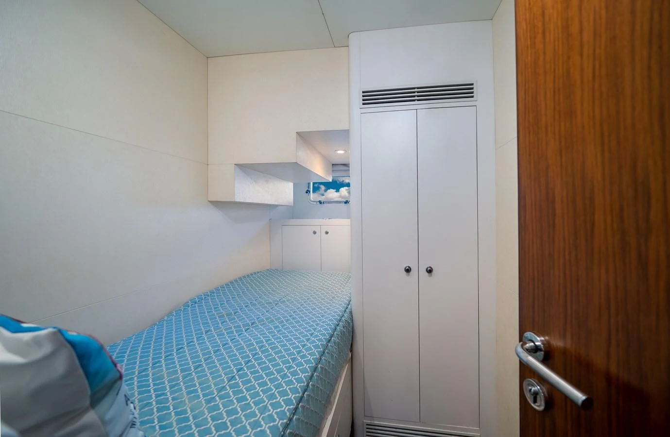 a room with a bed and a closet aboard SEA N SEA Yacht for Sale
