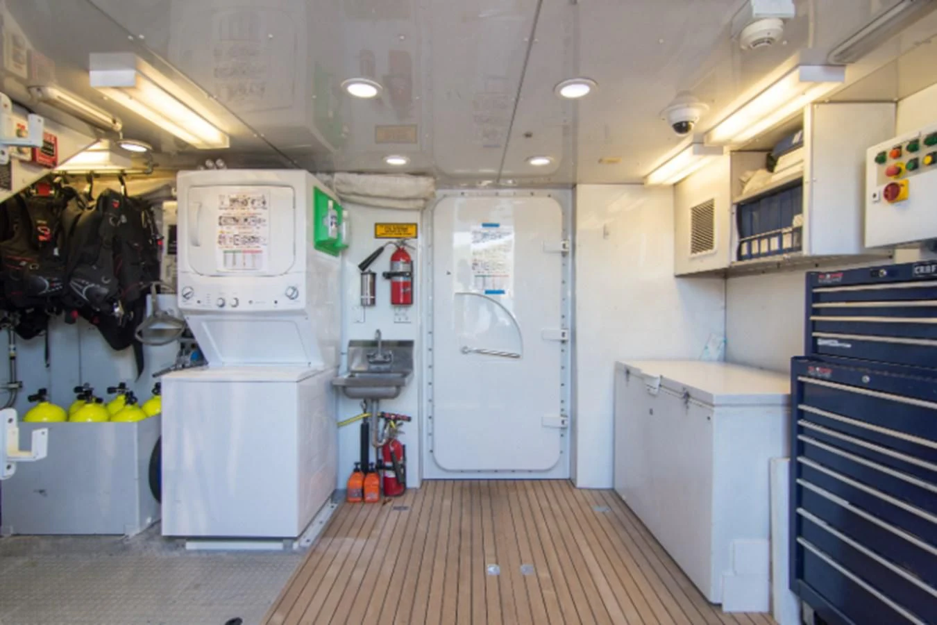 a large kitchen with white appliances aboard ADVENTURER Yacht for Sale