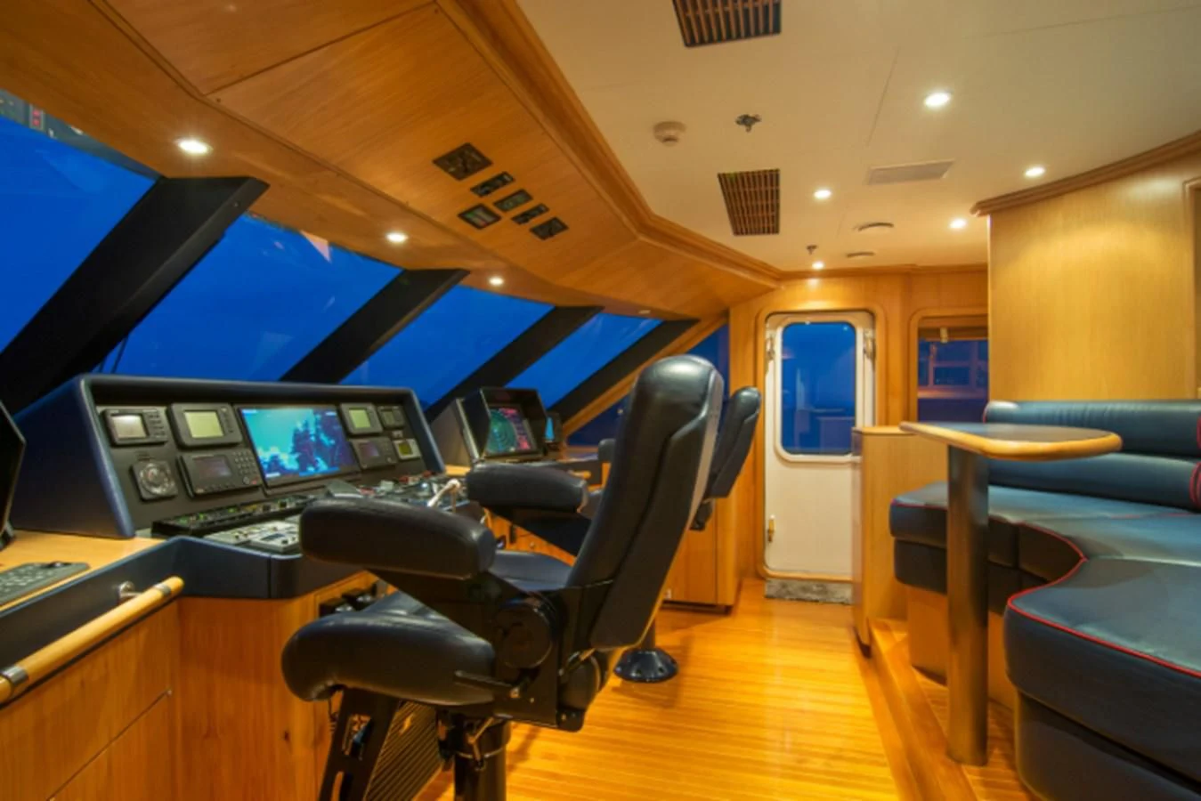 a room with a desk and chairs aboard ADVENTURER Yacht for Sale