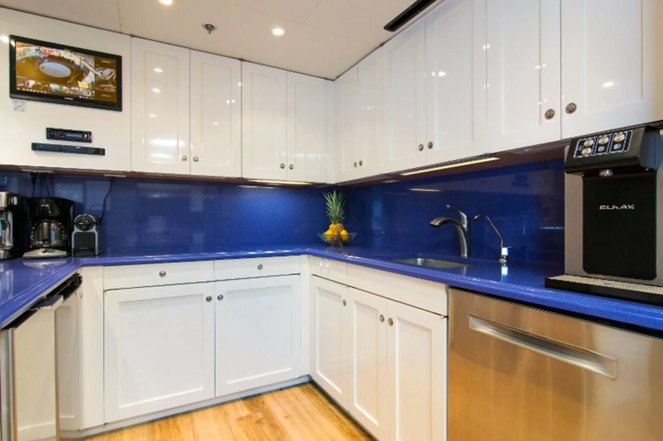 a kitchen with white cabinets aboard ADVENTURER Yacht for Sale