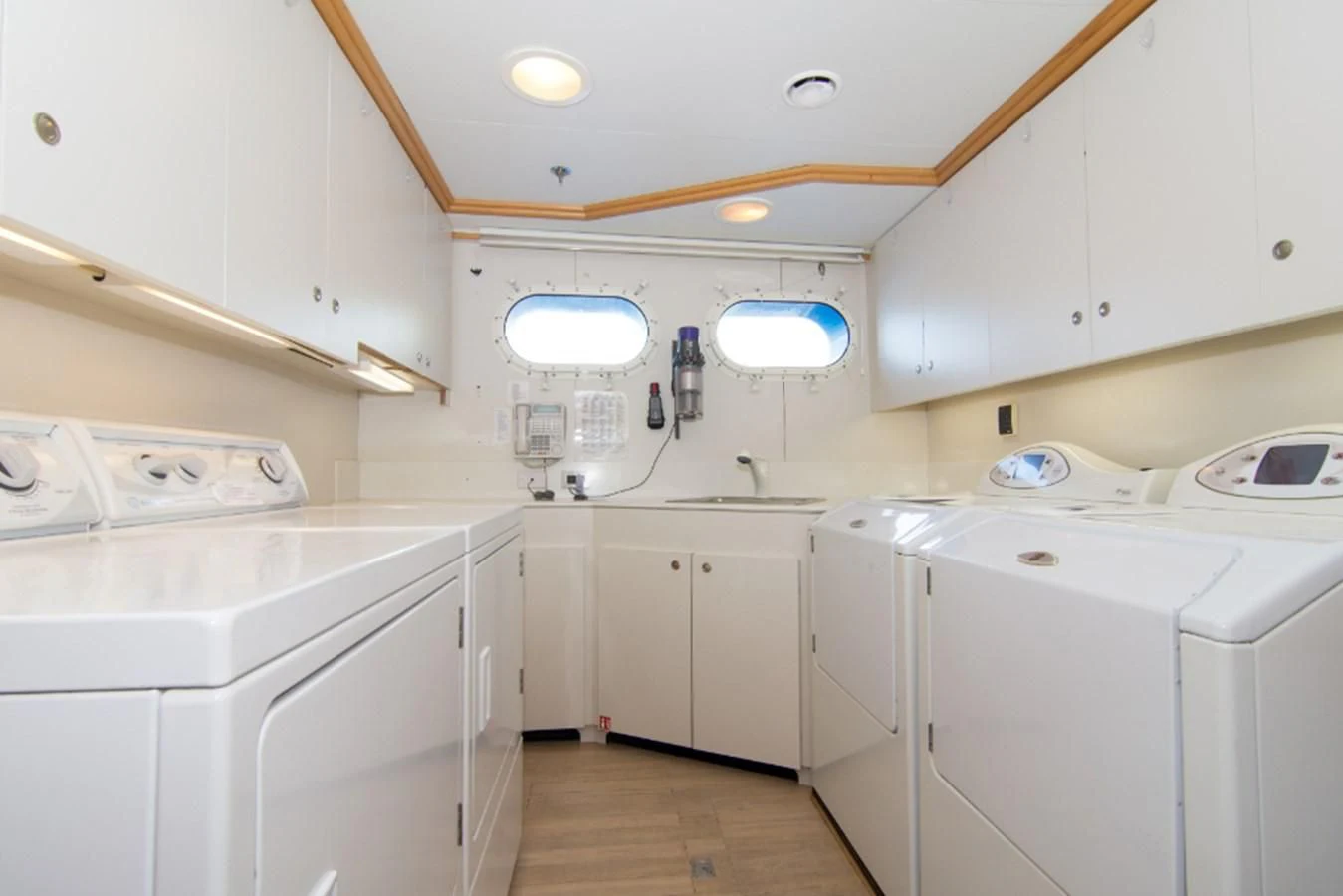a kitchen with white cabinets aboard ADVENTURER Yacht for Sale