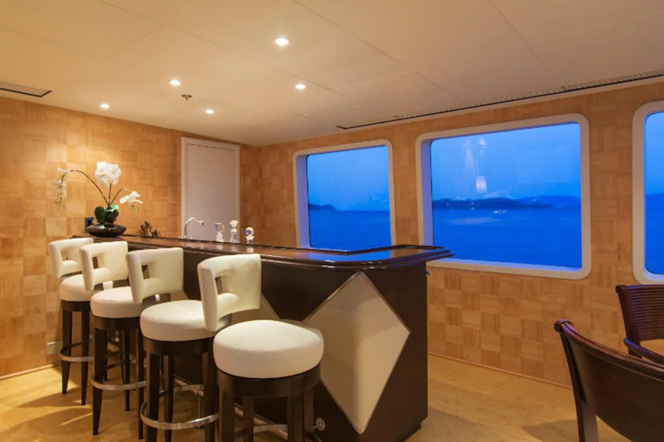 a room with a table and chairs aboard ADVENTURER Yacht for Sale