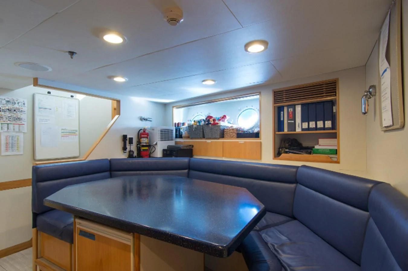 a living room with a table and couches aboard ADVENTURER Yacht for Sale
