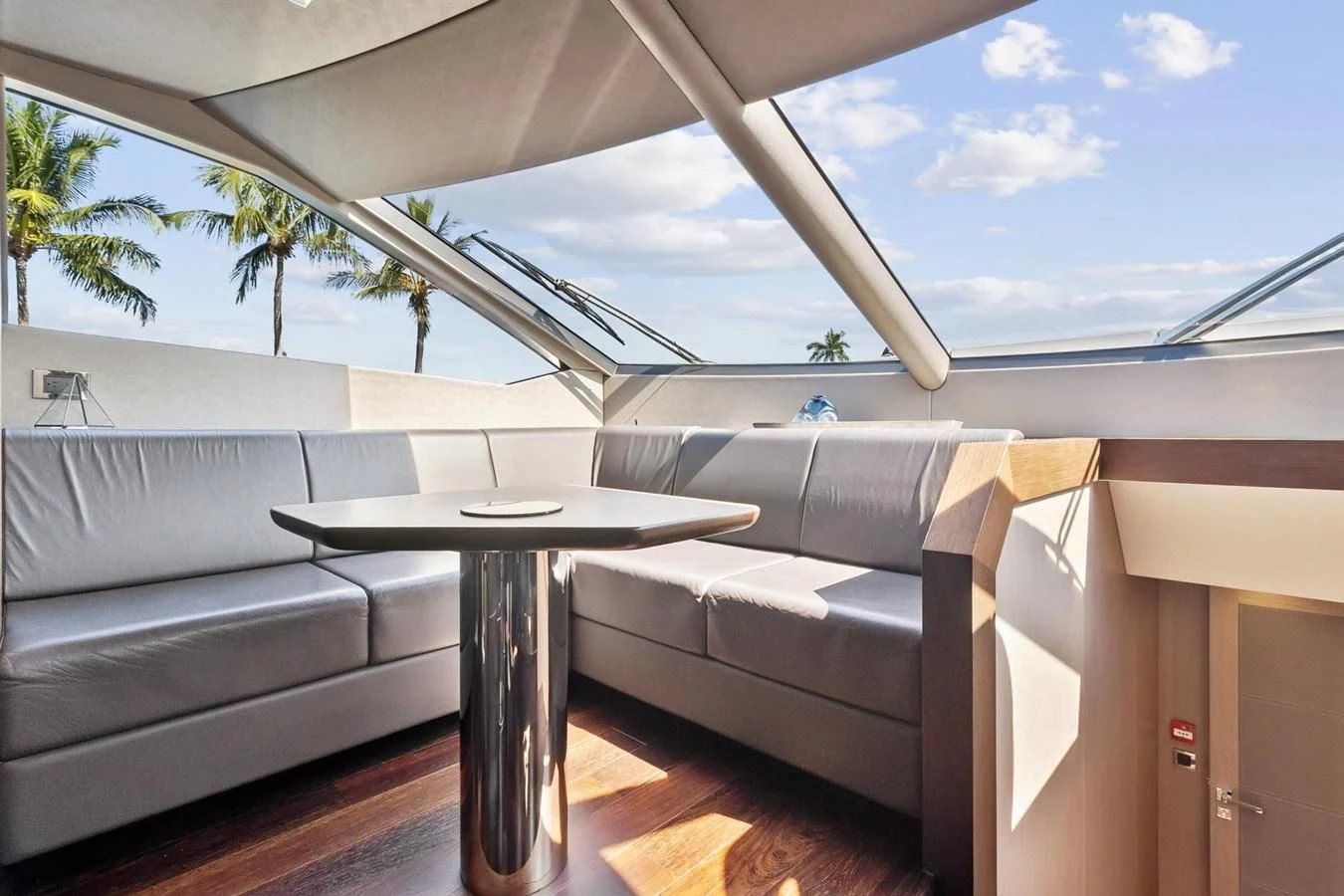 a table and a couch in a room with a pool aboard F5 Yacht for Sale