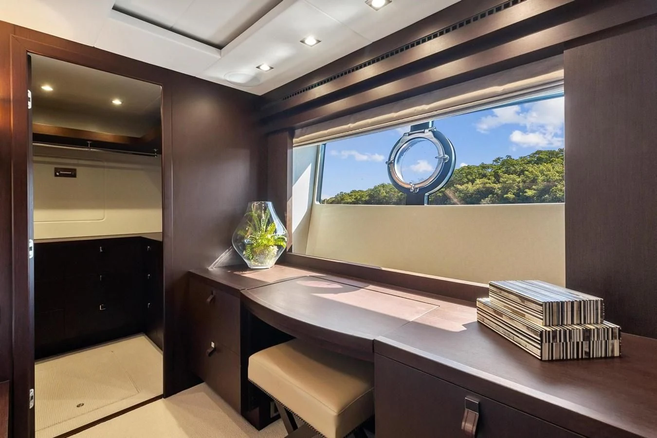 a room with a large window and a desk with a large blue window aboard F5 Yacht for Sale