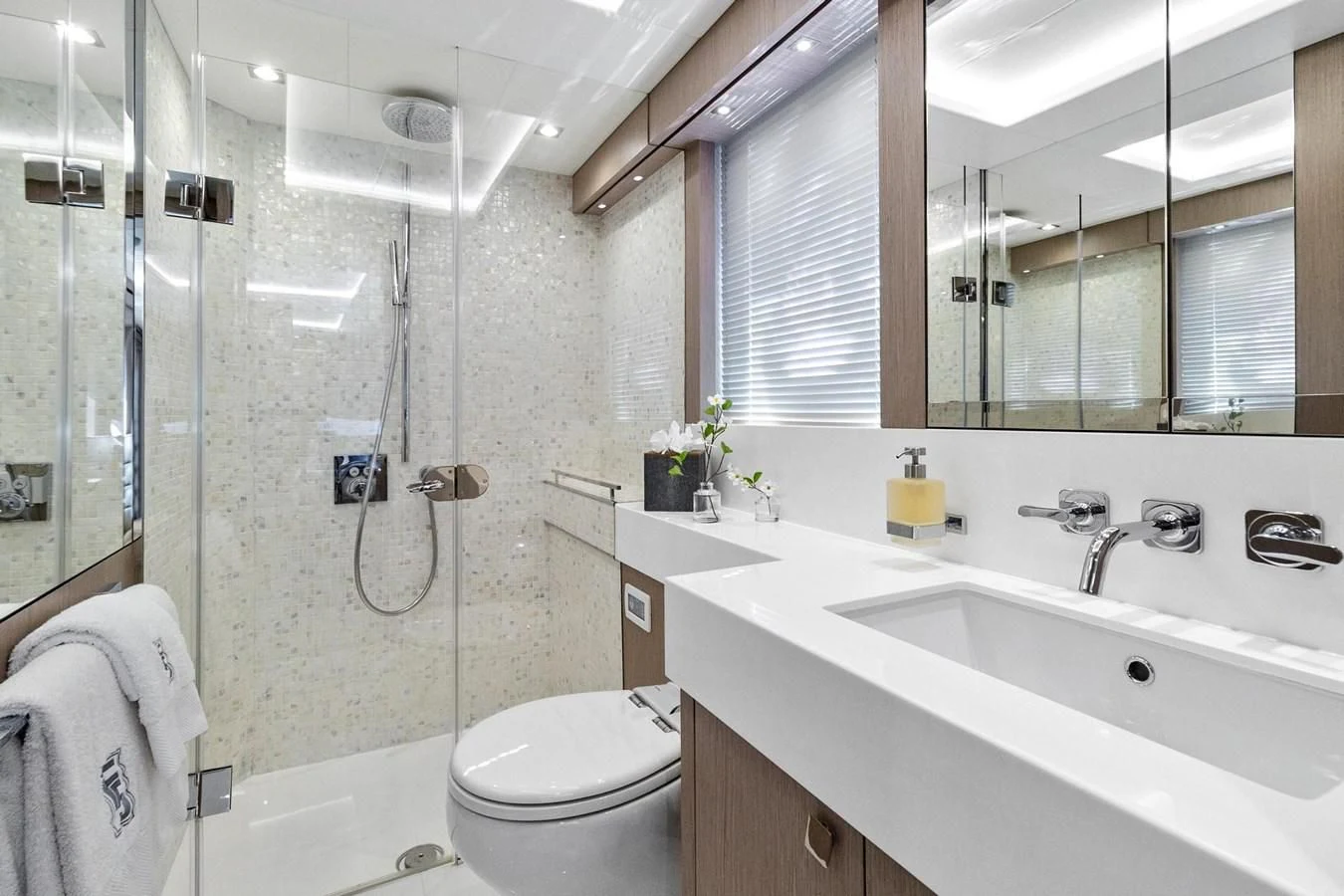 a bathroom with a shower sink and toilet aboard F5 Yacht for Sale