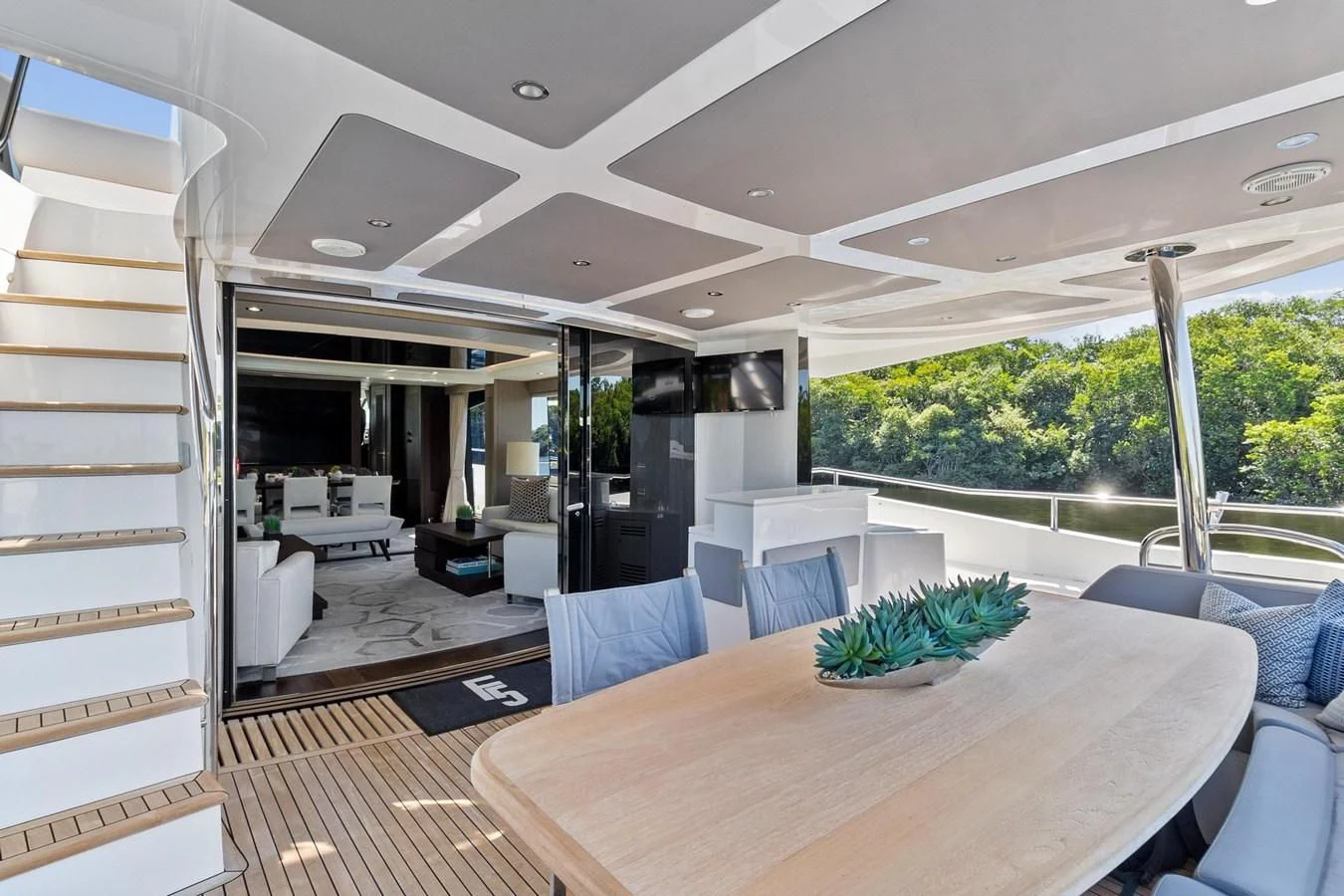 a large open house with a large table and chairs aboard F5 Yacht for Sale