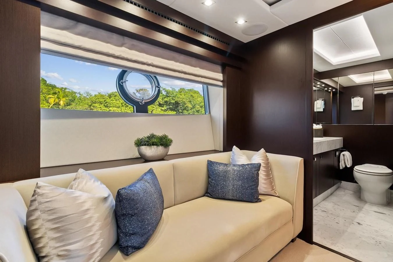 a living room with a couch and a large window aboard F5 Yacht for Sale
