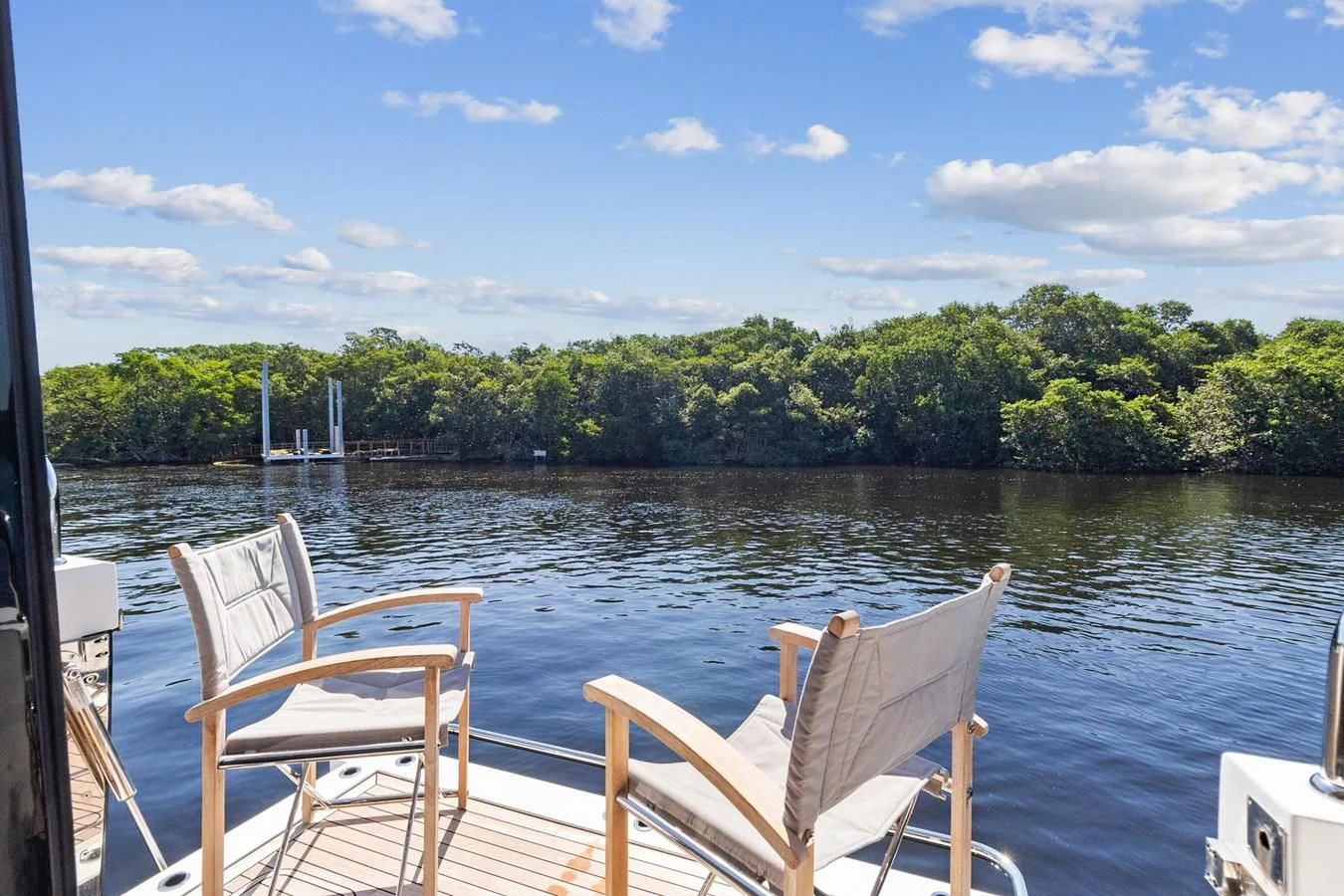 chairs on a dock by a body of water aboard F5 Yacht for Sale