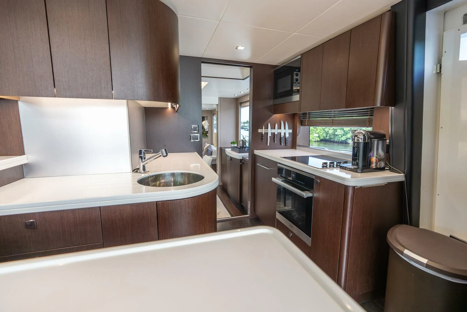 a kitchen with wooden cabinets aboard F5 Yacht for Sale