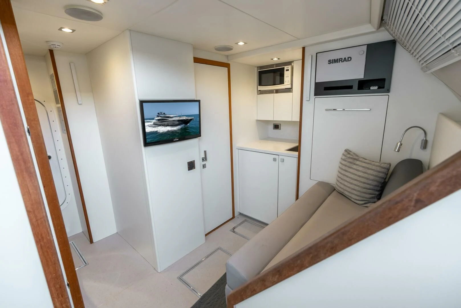 a kitchen with a bed and microwave aboard F5 Yacht for Sale