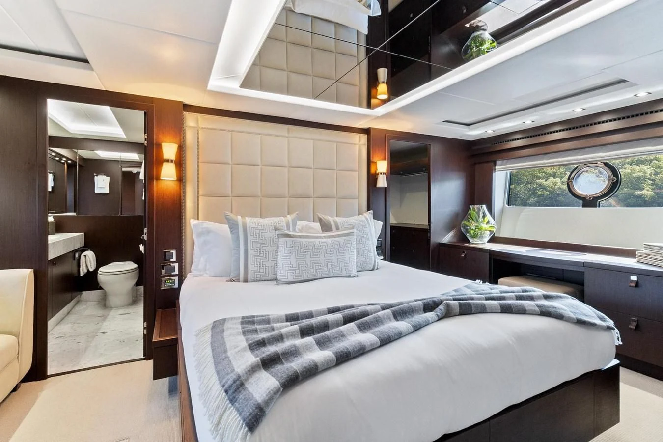 a bedroom with a bed and a desk aboard F5 Yacht for Sale