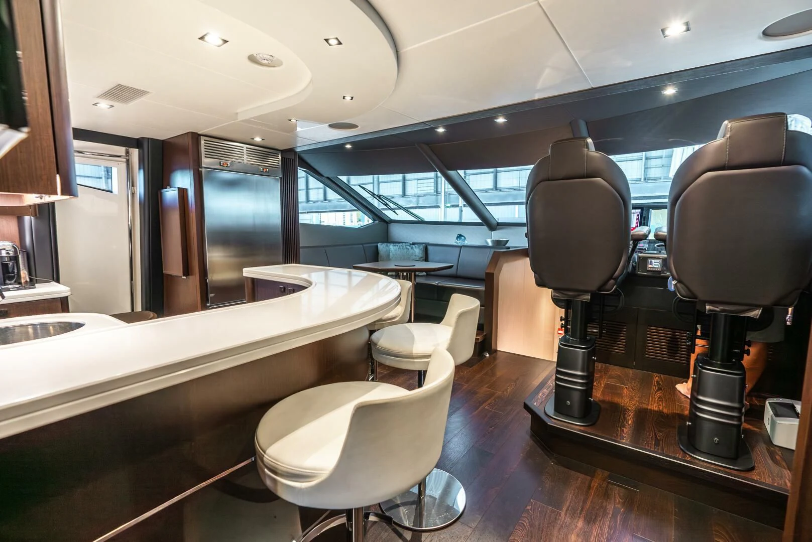 a room with a table and chairs aboard F5 Yacht for Sale